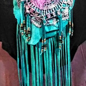 Handmade deerskin crossbody bag embellished with embroidery and beaded fringe